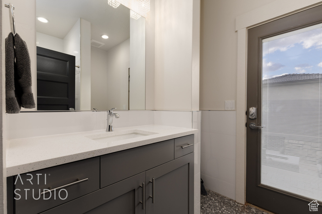 Bathroom featuring recessed lighting, visible vents, and vanity