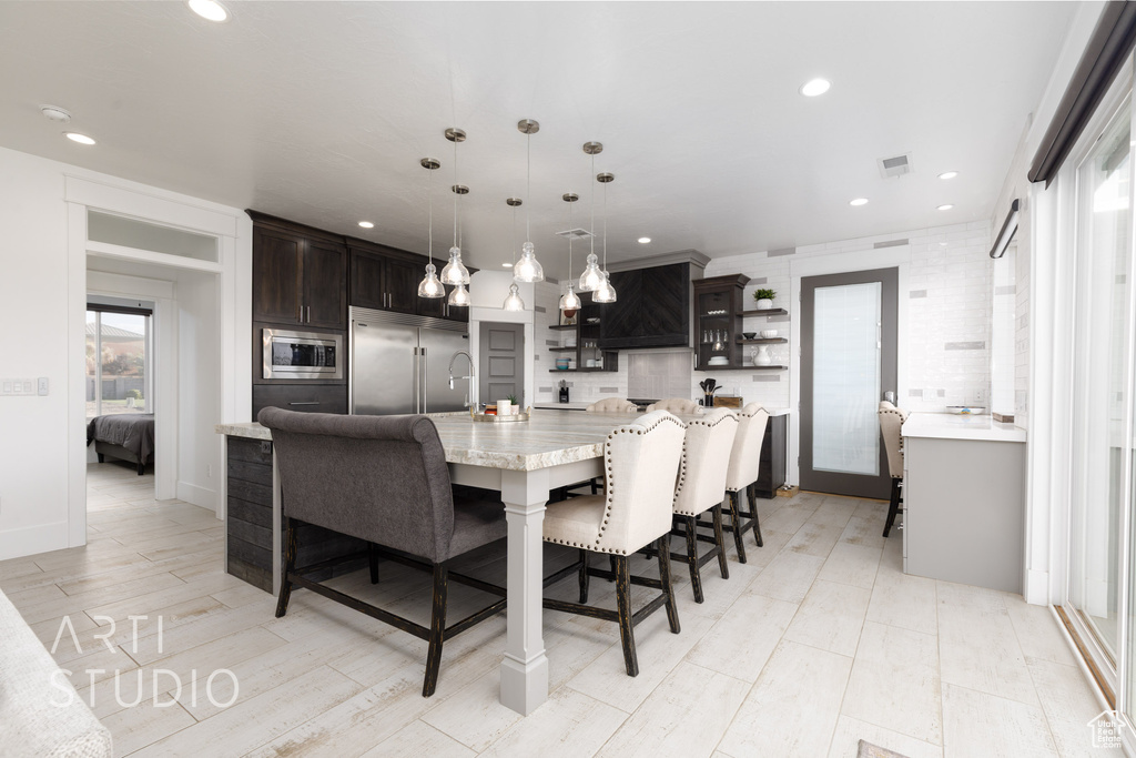 Dining space with light wood-type flooring, recessed lighting, and visible vents