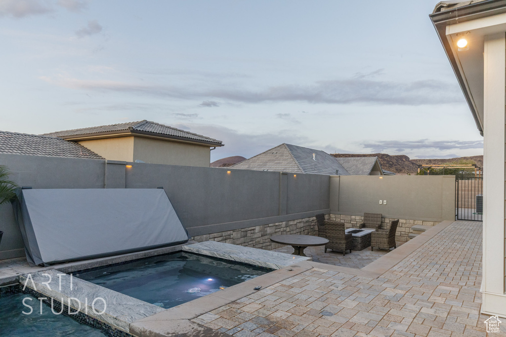 View of pool with a fenced backyard, a patio, and an in ground hot tub