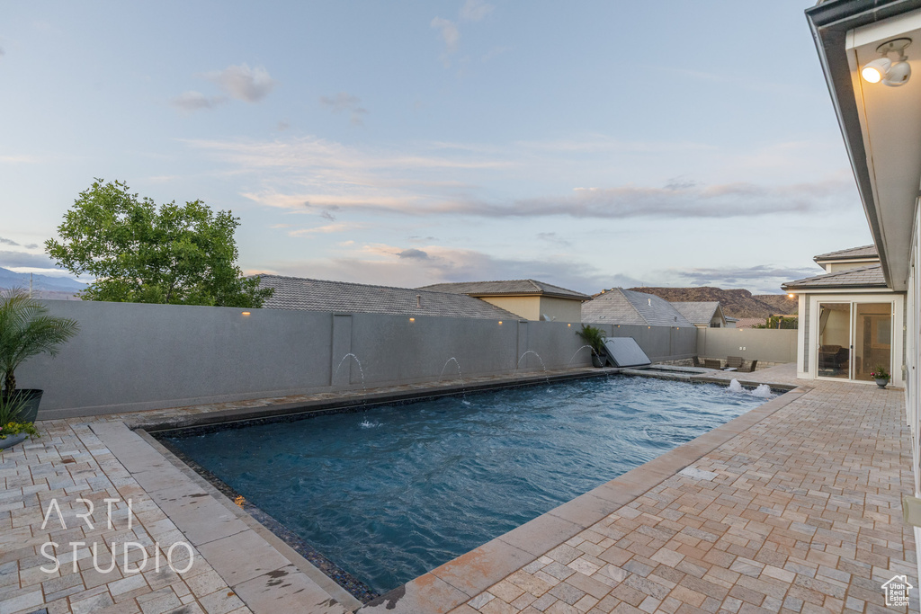 View of pool featuring a fenced backyard, a fenced in pool, and a patio area