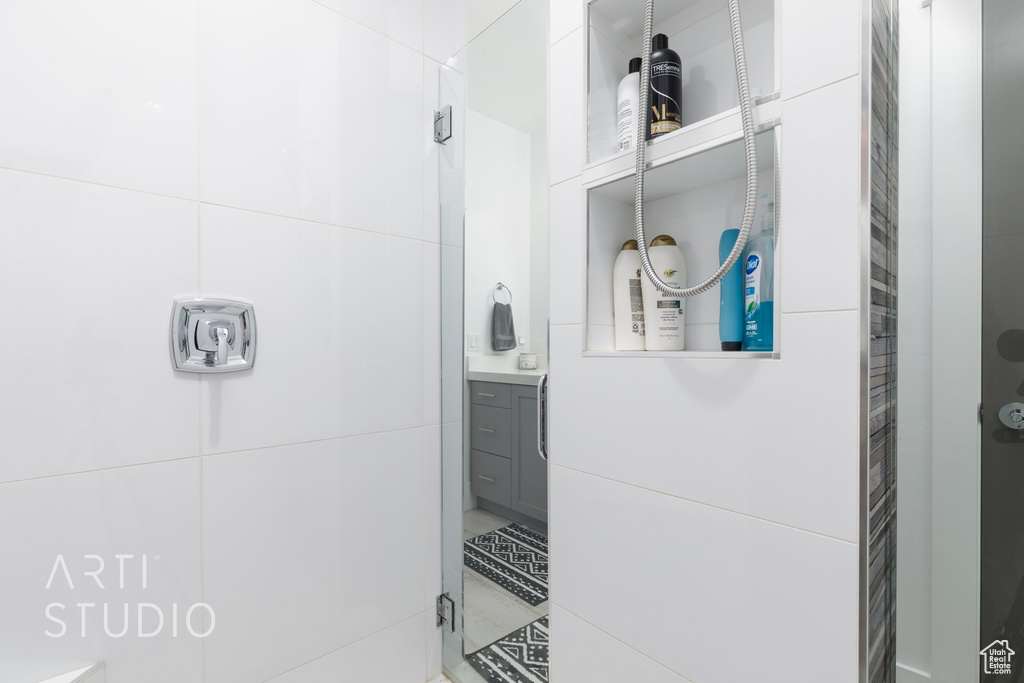 Bathroom featuring vanity and a shower