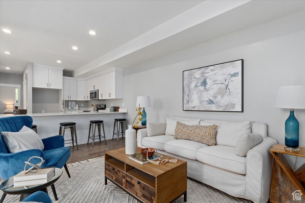 Living area featuring recessed lighting and light wood-style flooring