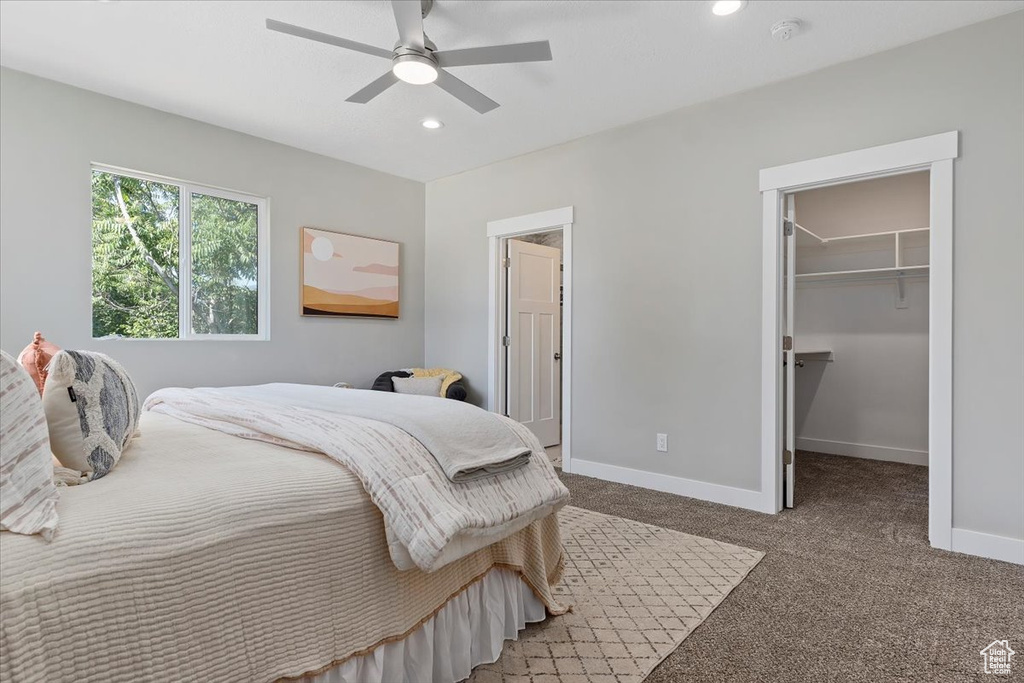 Bedroom featuring carpet floors, recessed lighting, baseboards, and a walk in closet