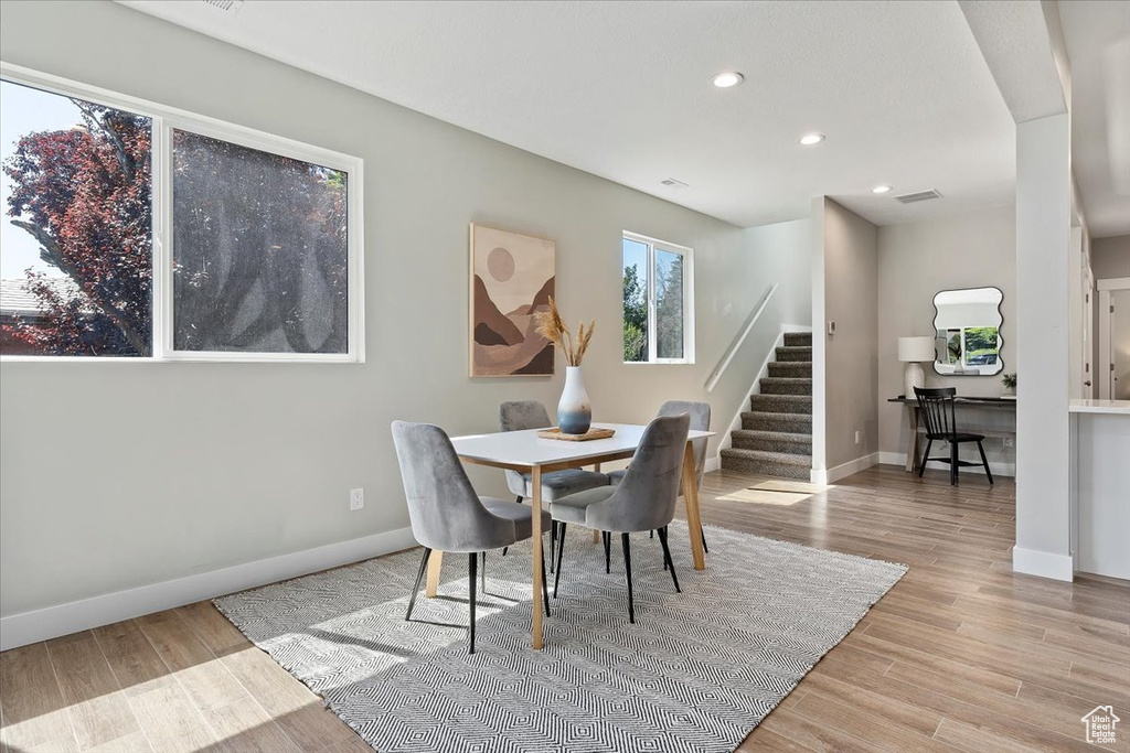 Dining area with visible vents, baseboards, stairway, recessed lighting, and light wood-style flooring