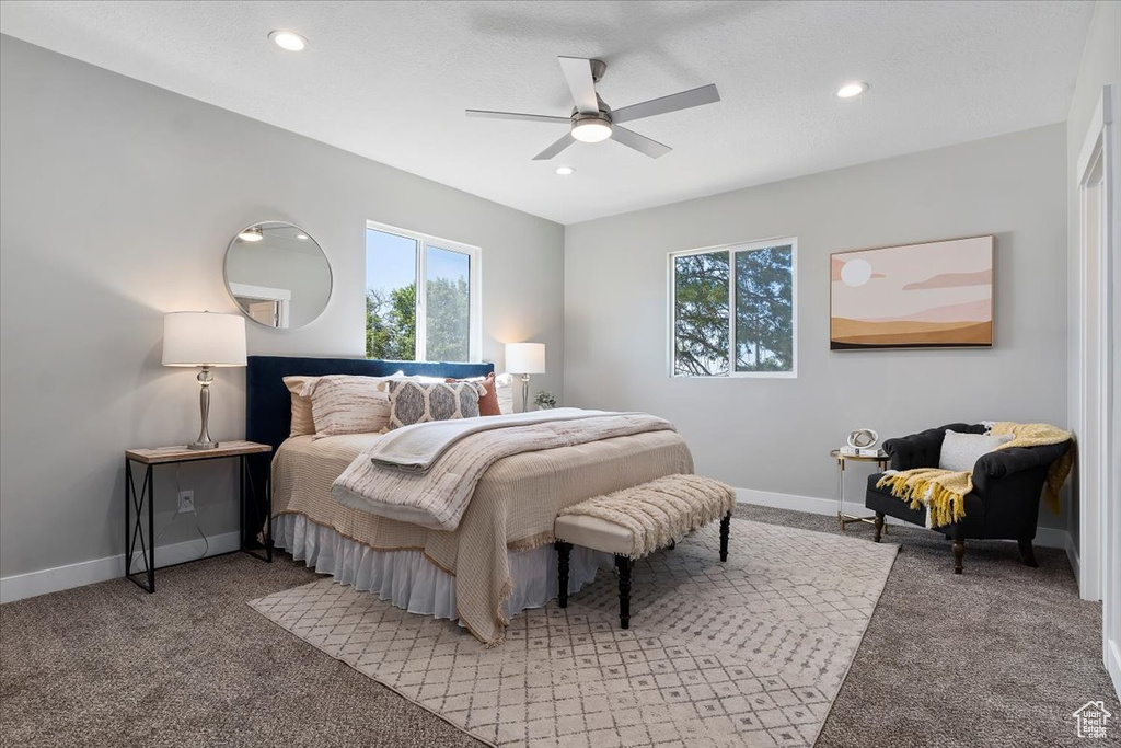 Bedroom with baseboards, multiple windows, recessed lighting, and light colored carpet