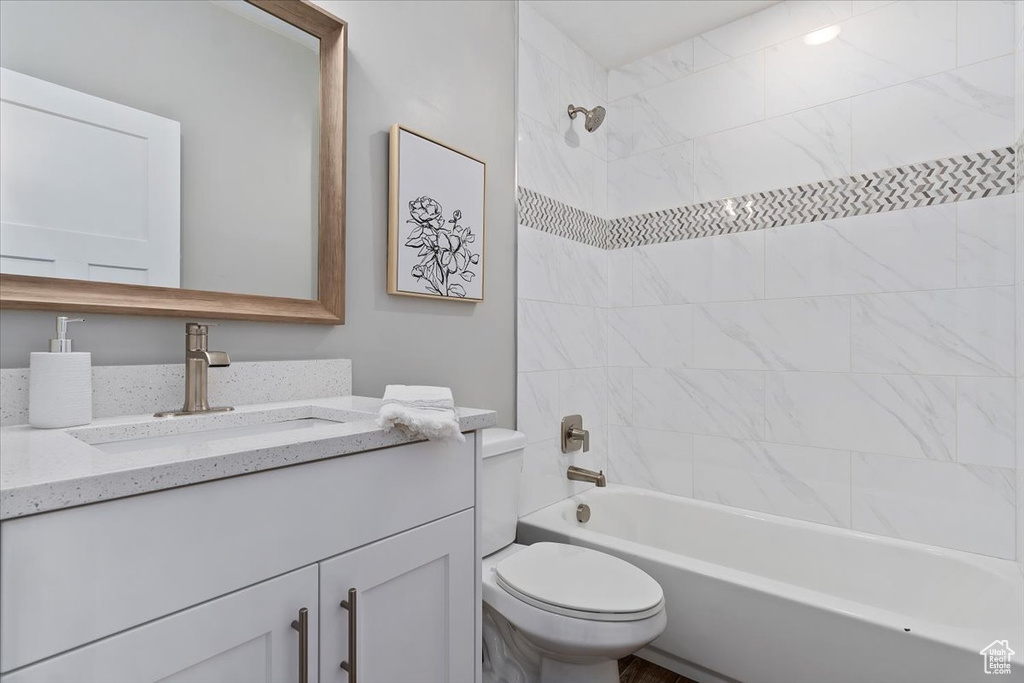 Full bathroom with vanity, bathing tub / shower combination, and toilet