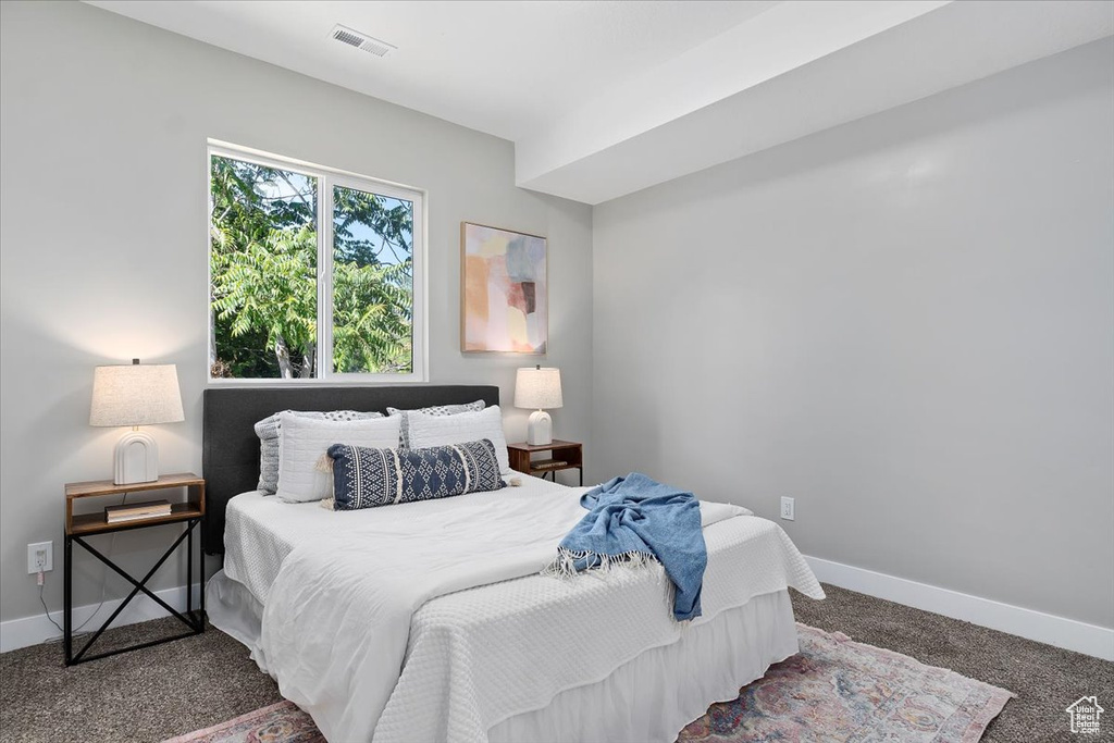 Bedroom with baseboards, carpet floors, and visible vents