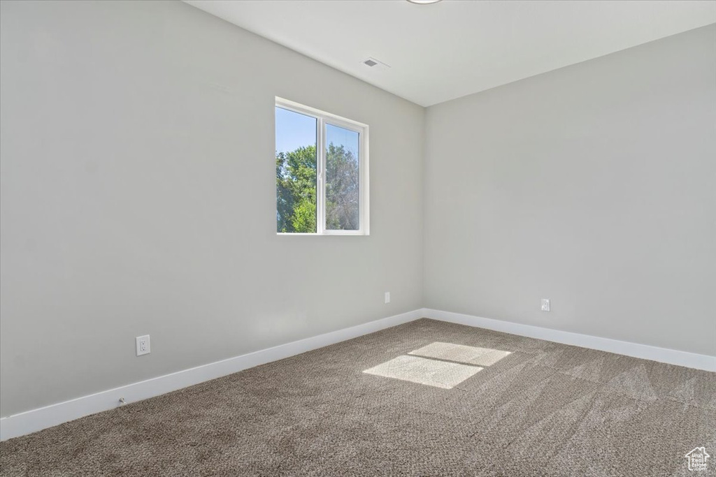 Unfurnished room featuring carpet flooring and baseboards