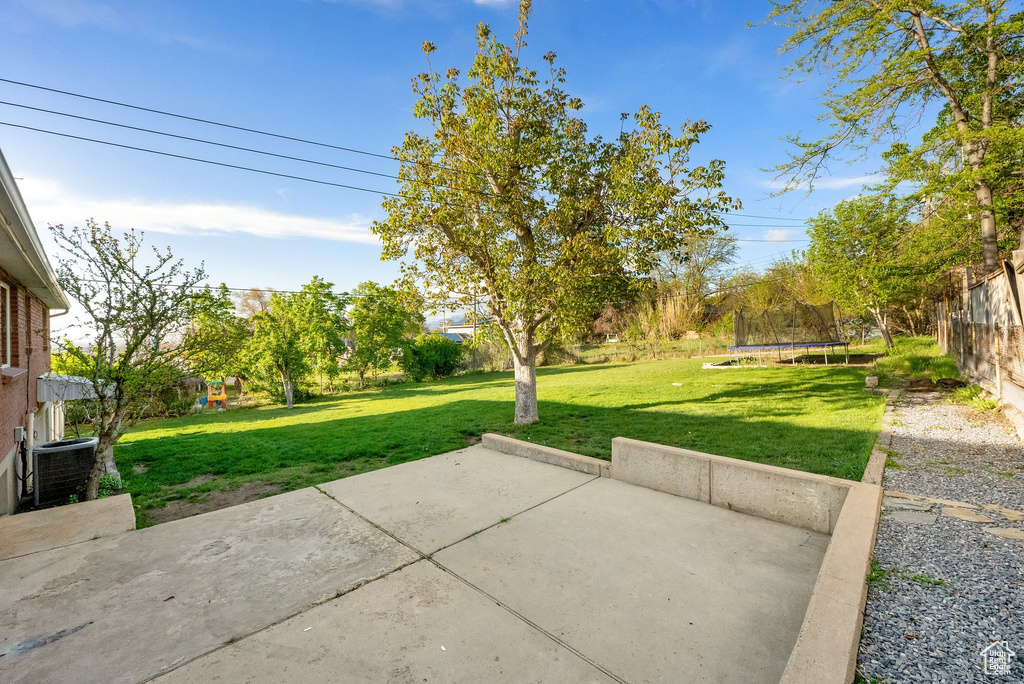 View of patio / terrace with a fenced backyard and a trampoline