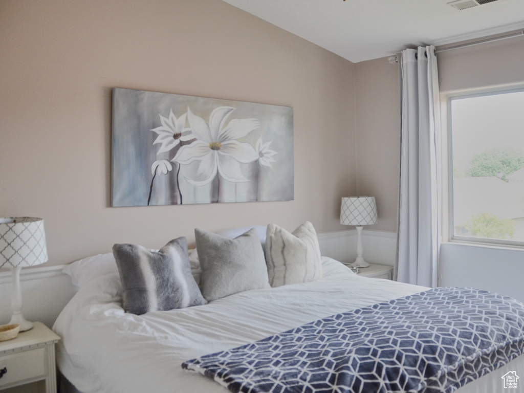 Bedroom featuring ceiling fan and visible vents
