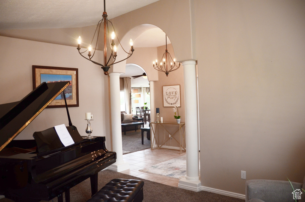 Hallway featuring an inviting chandelier, arched walkways, carpet floors, and lofted ceiling