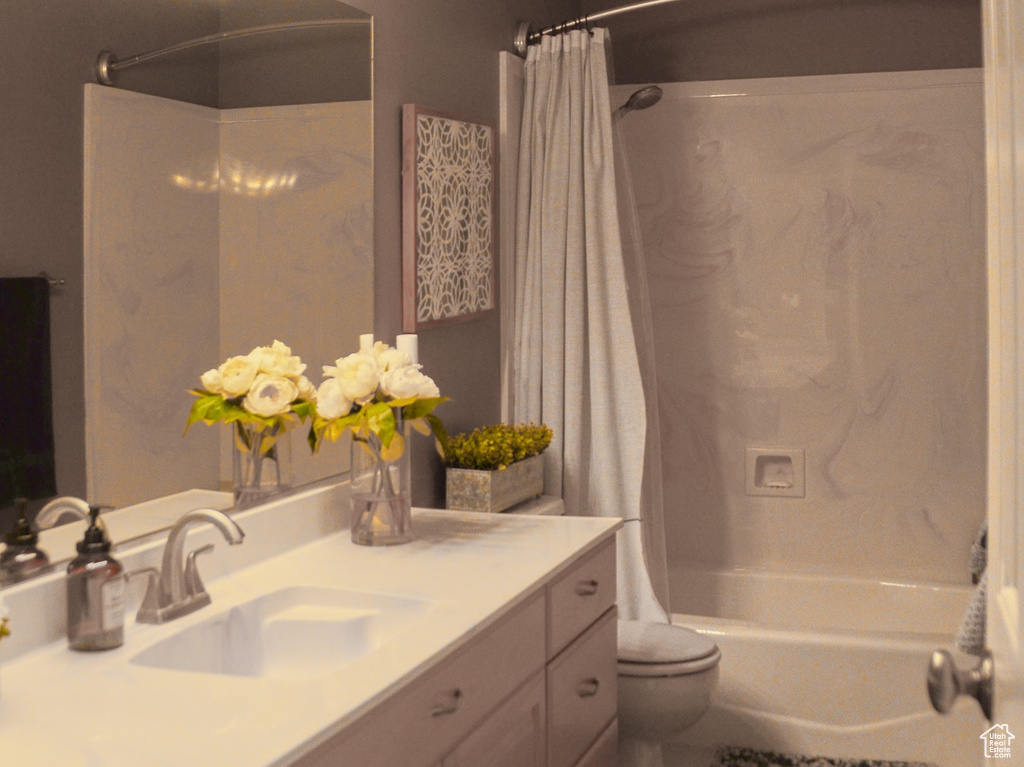 Bathroom featuring visible vents, shower / tub combo with curtain, toilet, and vanity