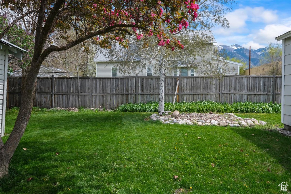 View of yard featuring fence and a mountain view