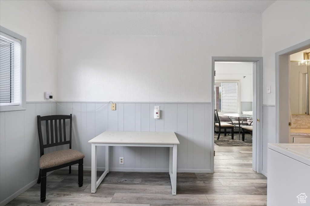 Sitting room with wainscoting, a wealth of natural light, and light wood-type flooring