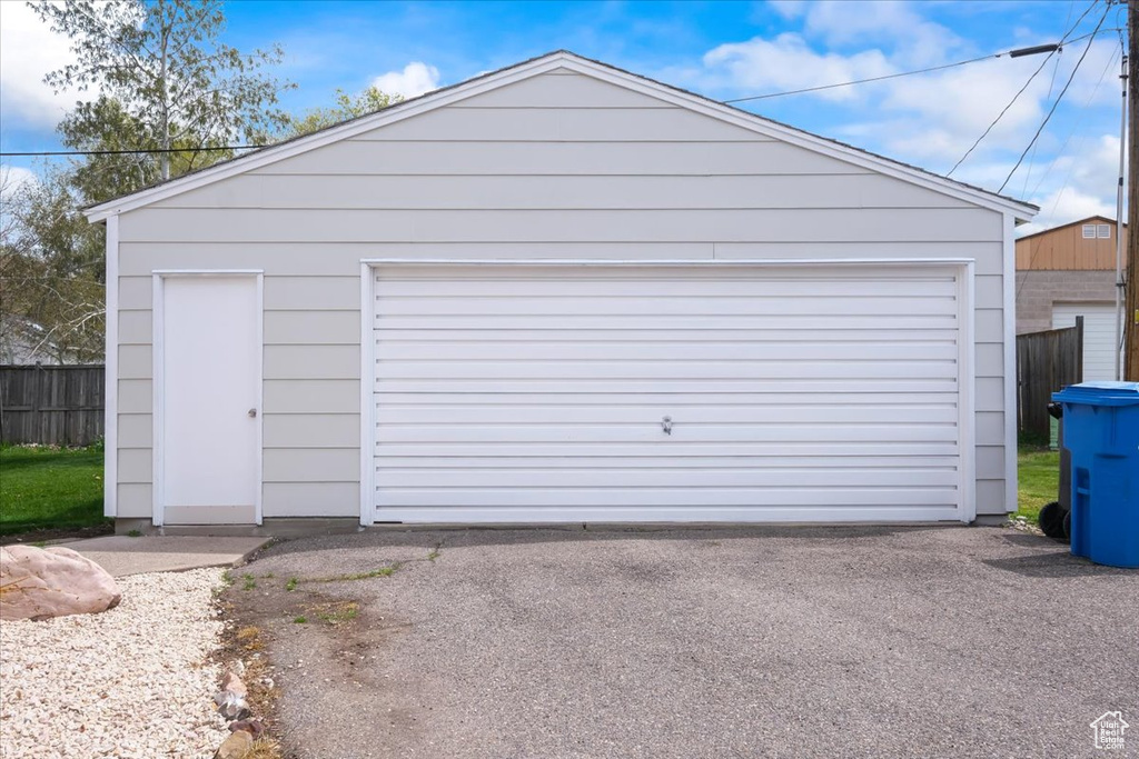 Detached garage featuring fence