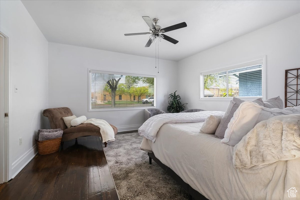 Bedroom with hardwood / wood-style floors, baseboards, and a ceiling fan