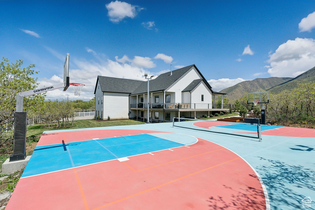 View of sport court featuring community basketball court, fence, and a mountain view