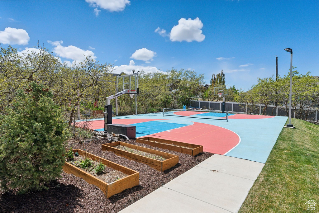 View of basketball court featuring fence and community basketball court
