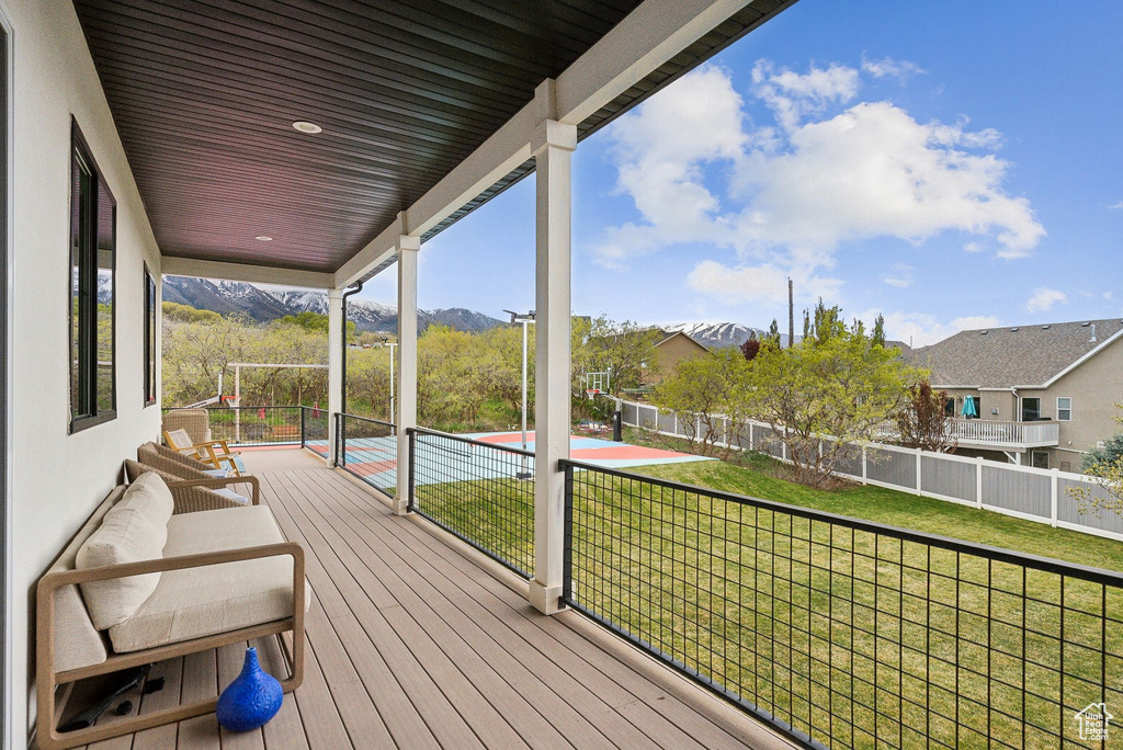 Wooden terrace with fence and a yard