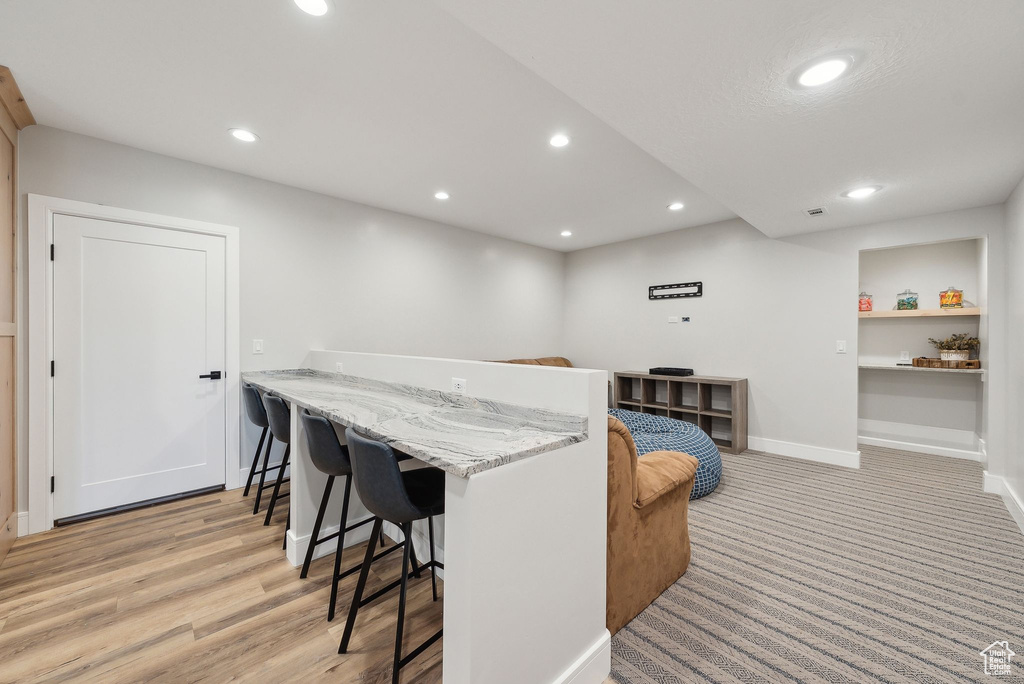 Bar featuring recessed lighting, baseboards, and light wood-type flooring