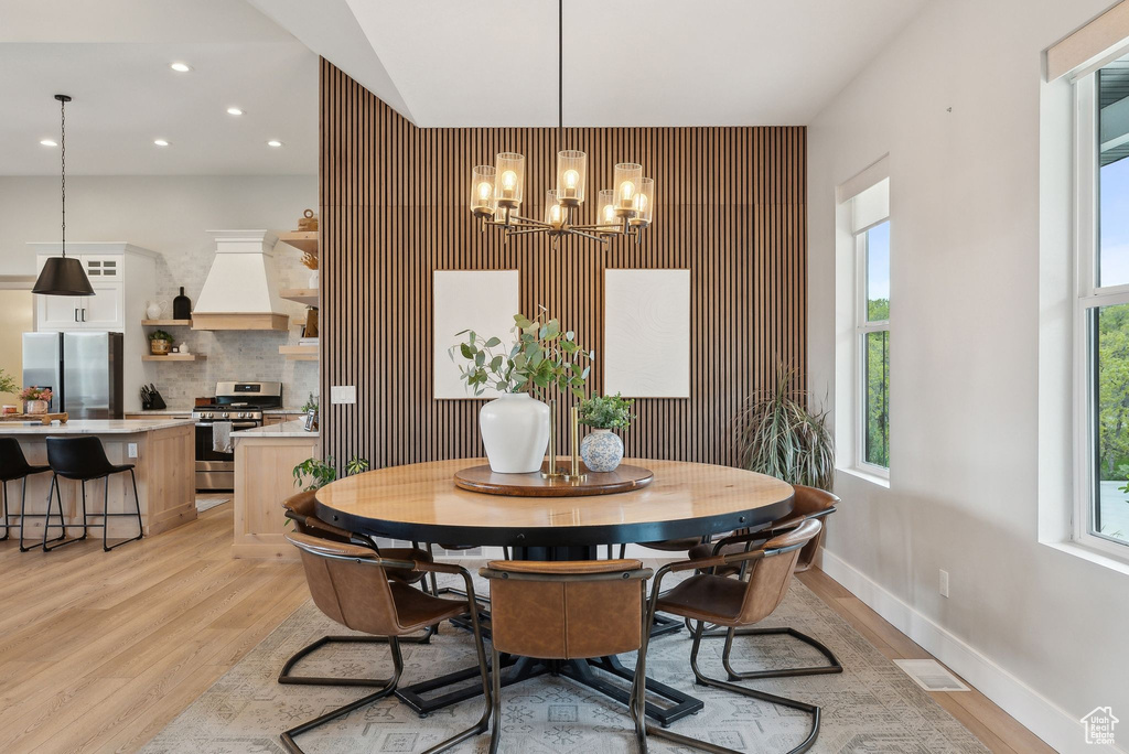 Dining room with recessed lighting, an inviting chandelier, visible vents, and light wood-type flooring