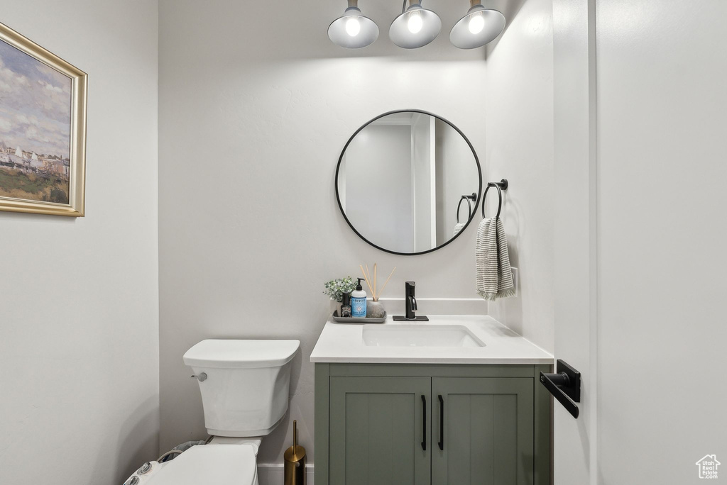 Half bathroom with toilet and vanity