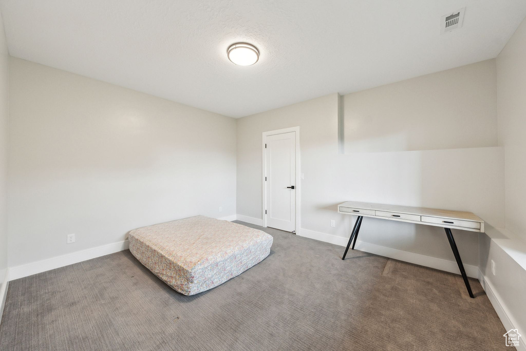 Bedroom featuring carpet floors, baseboards, and visible vents