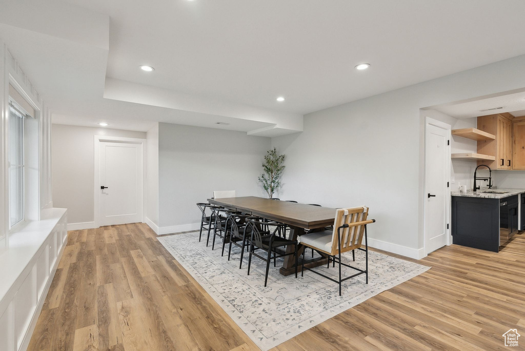Dining space with recessed lighting, baseboards, and light wood-style flooring