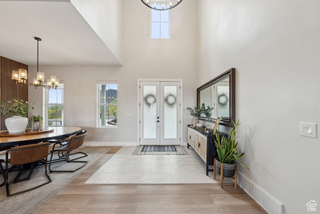 Entrance foyer with an inviting chandelier, plenty of natural light, french doors, and visible vents