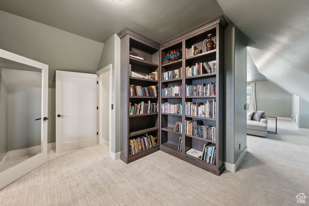 Interior space with carpet floors, baseboards, vaulted ceiling, and french doors