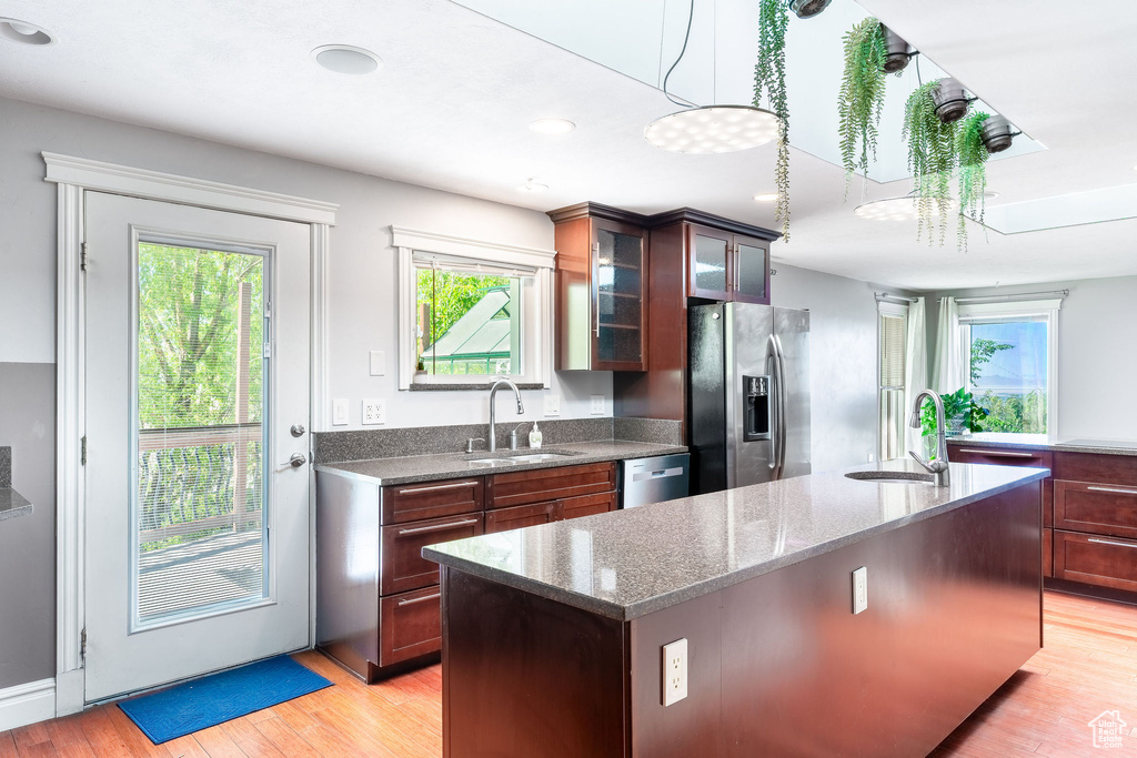 Kitchen featuring stainless steel appliances, a healthy amount of sunlight, and a sink