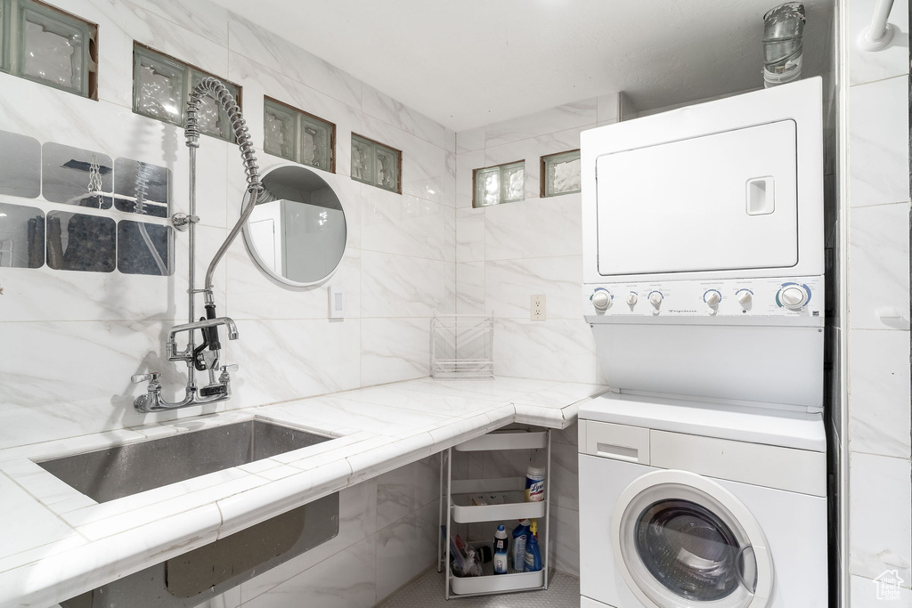 Clothes washing area featuring stacked washer / dryer