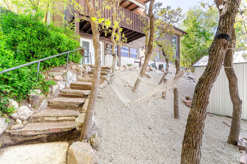 View of yard with stairway and a deck