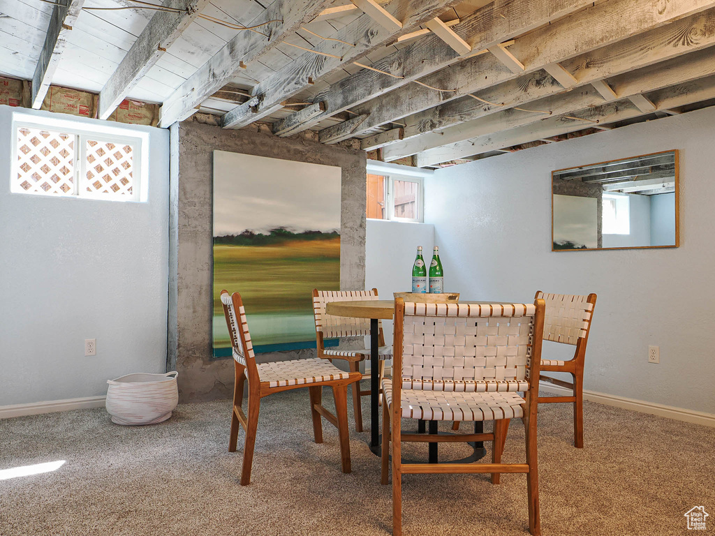 Dining area featuring baseboards, carpet flooring, and a wealth of natural light