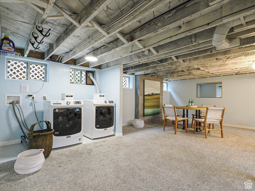 Laundry area featuring baseboards, laundry area, carpet flooring, and washer and clothes dryer