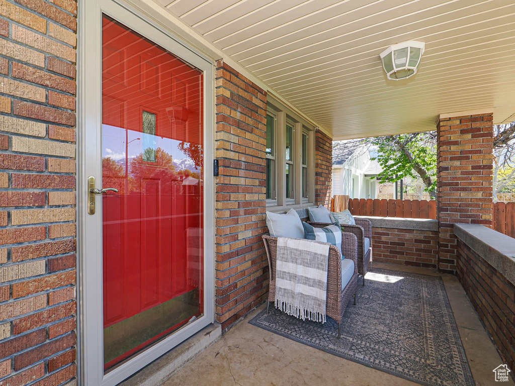 Exterior space featuring brick siding and covered porch