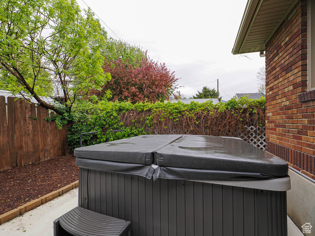 View of patio / terrace featuring a fenced backyard and a hot tub