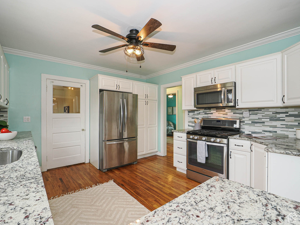 Kitchen featuring white cabinetry, appliances with stainless steel finishes, and dark wood-style floors