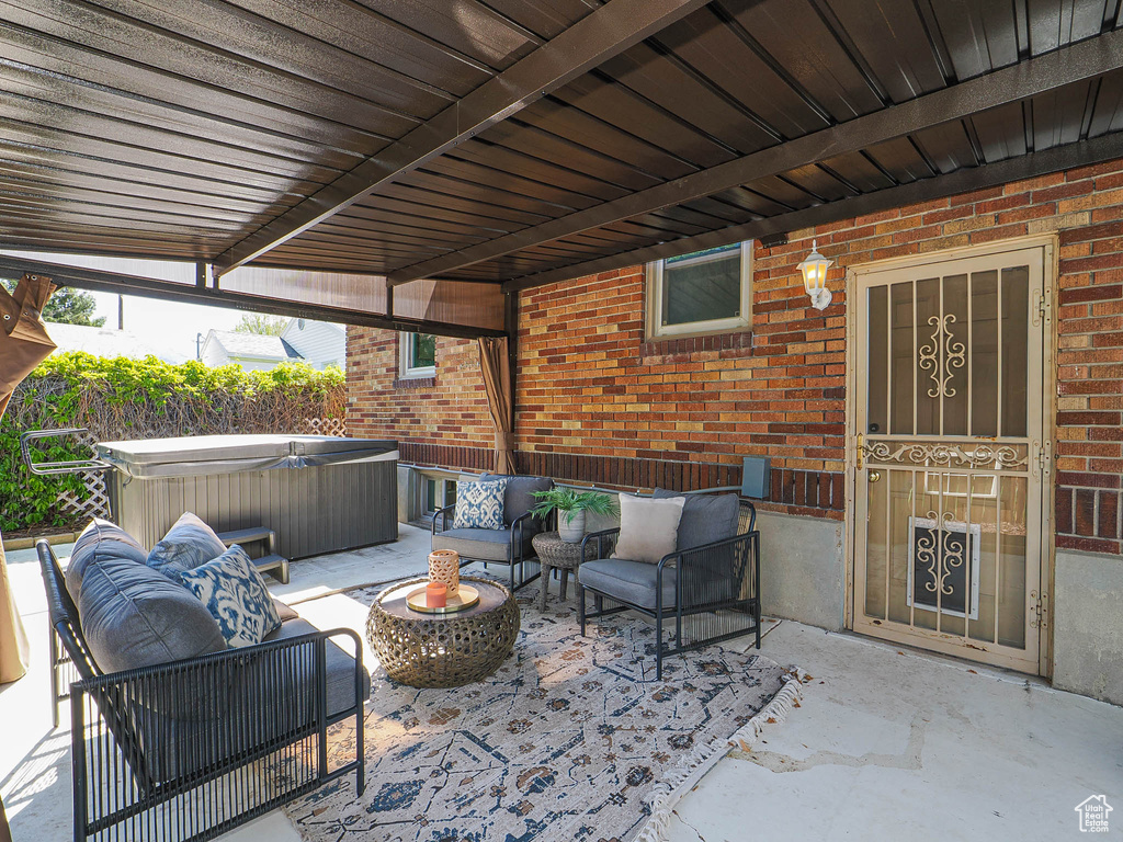 View of patio featuring a hot tub and outdoor lounge area
