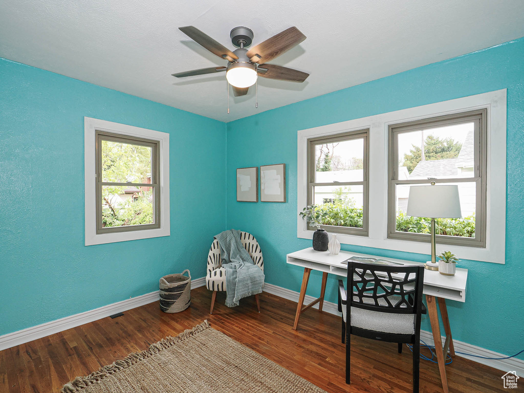 Office area with baseboards, ceiling fan, and wood finished floors