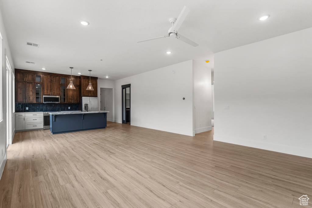 Unfurnished living room with recessed lighting, a ceiling fan, and light wood finished floors