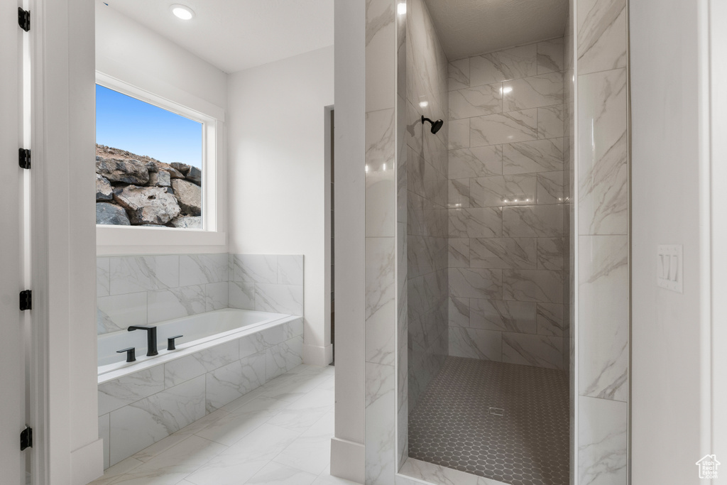 Bathroom with a bath, recessed lighting, a marble finish shower, and marble finish floor