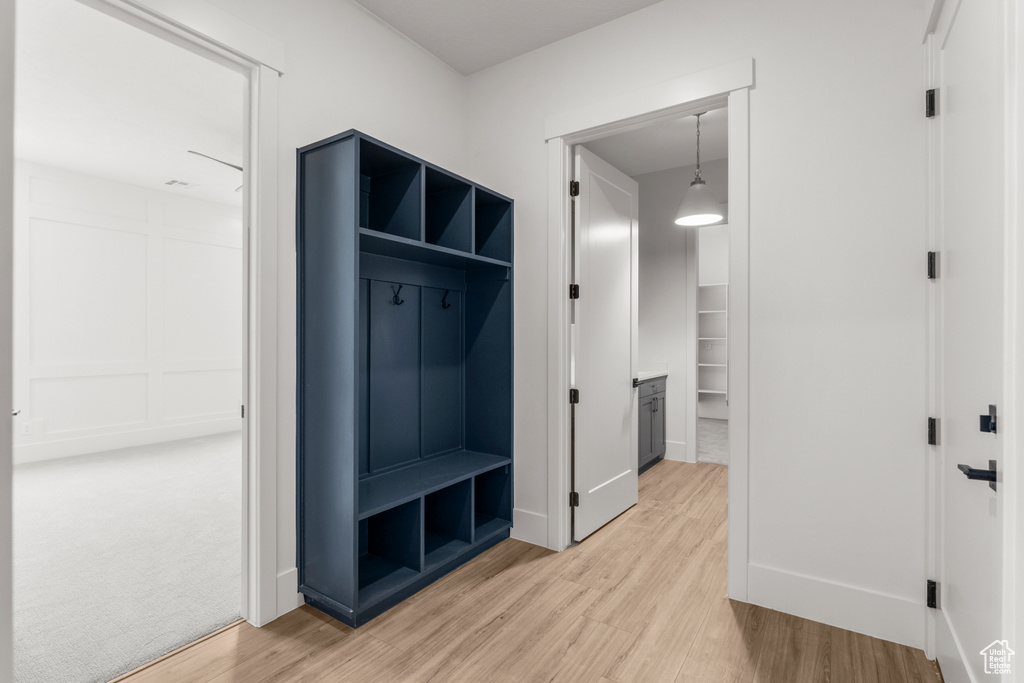Mudroom with baseboards and light wood finished floors