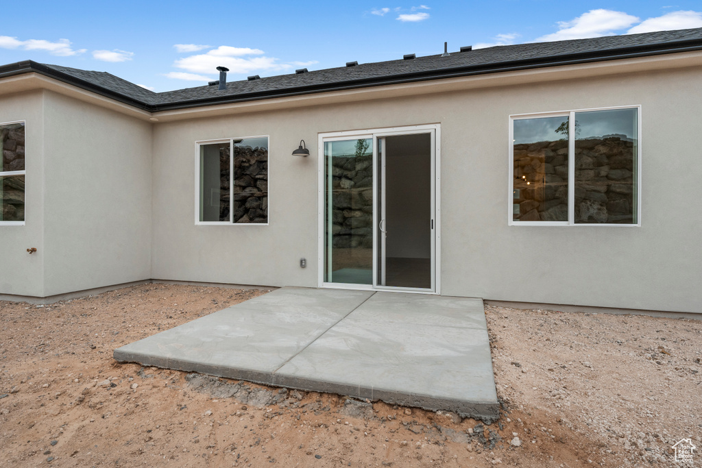 Back of house featuring a patio area and stucco siding