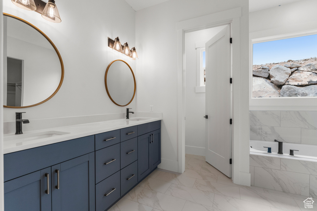 Full bathroom featuring a sink, baseboards, double vanity, and marble finish floor