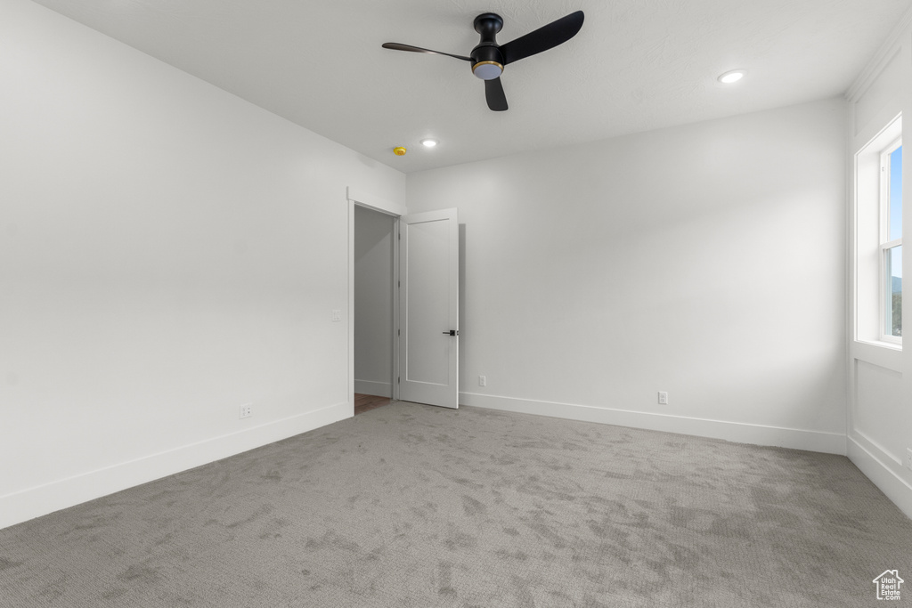 Carpeted spare room with baseboards, ceiling fan, and recessed lighting
