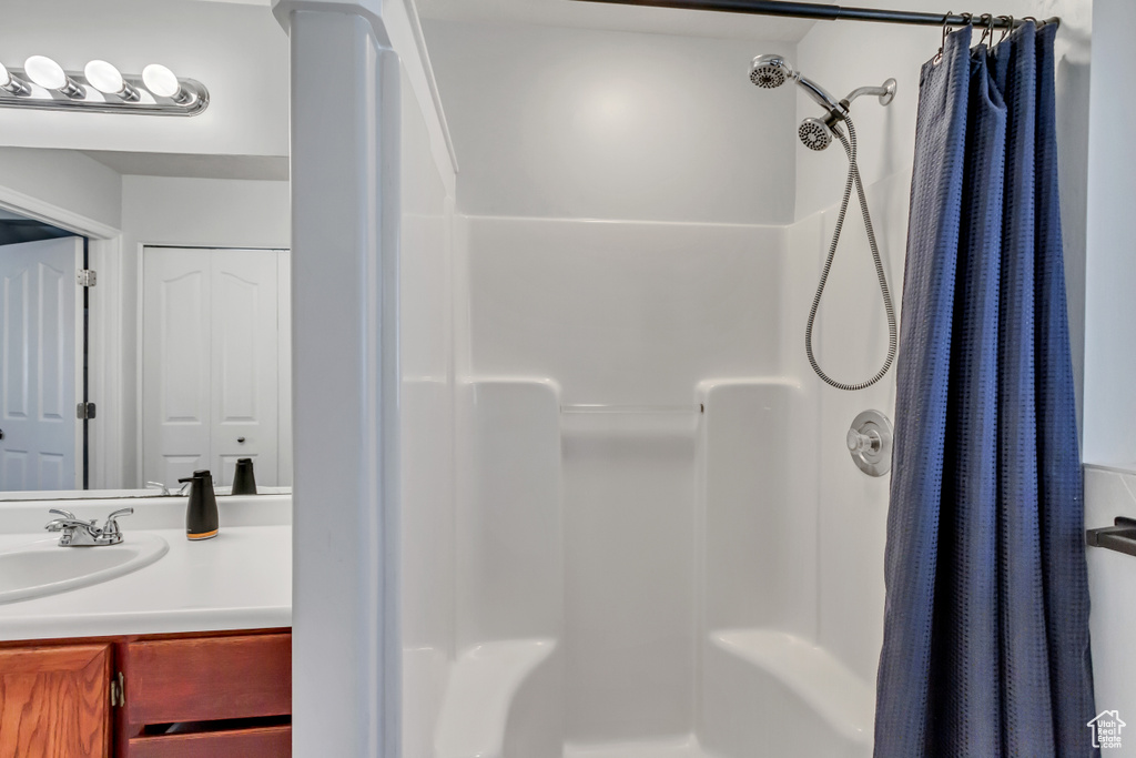 Bathroom featuring vanity and curtained shower