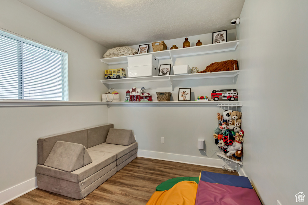 Sitting room with baseboards and wood finished floors