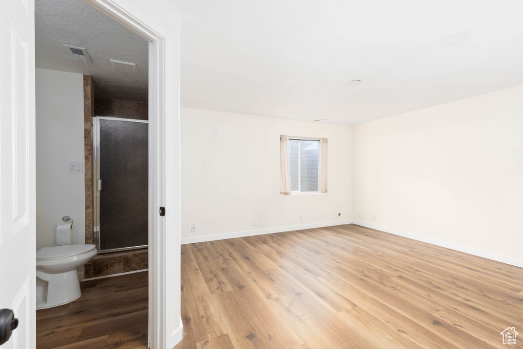 Spare room featuring baseboards, visible vents, and light wood-style flooring
