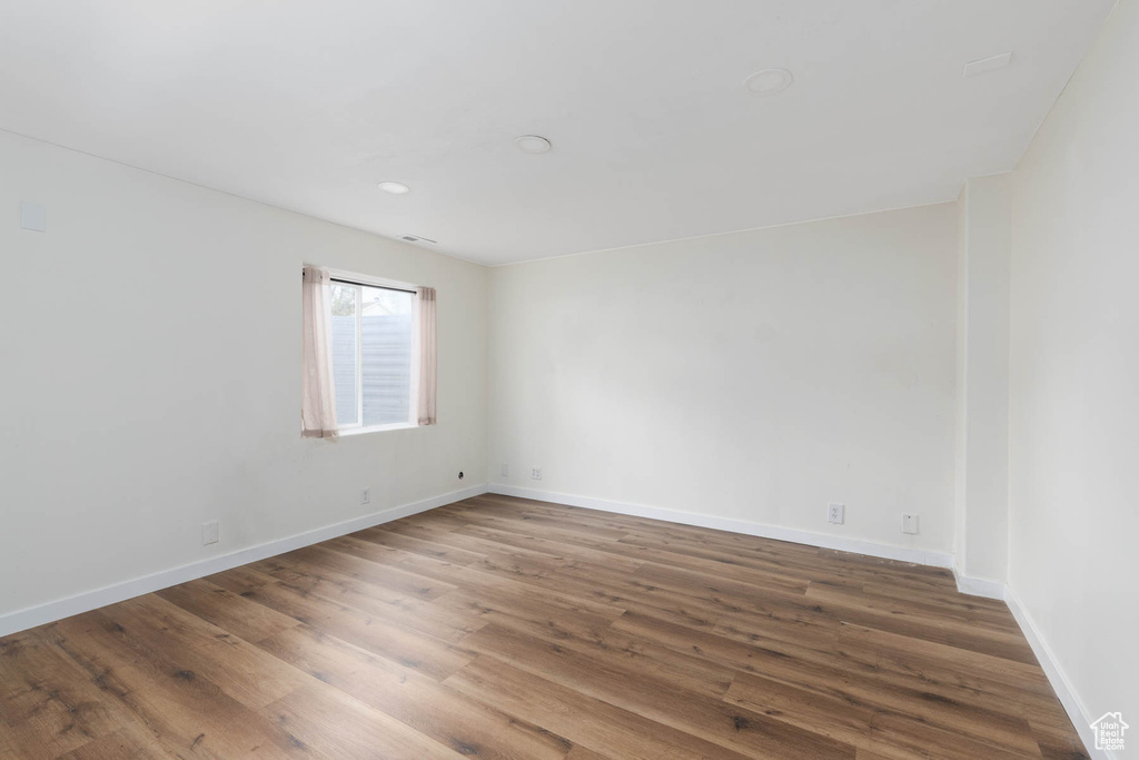 Unfurnished room featuring baseboards and wood finished floors